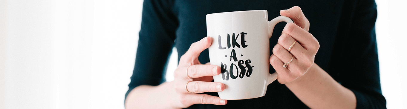 Woman's hands holding a white mug with the words "Like a Boss"﻿